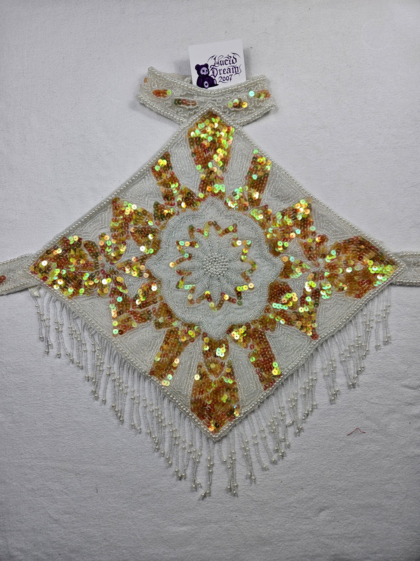 Espalda abierta bordada en blanco y dorado.