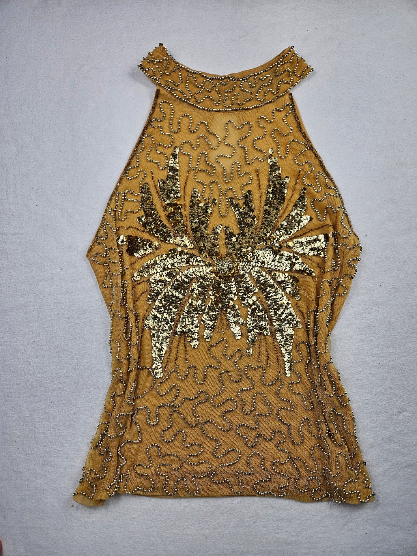 High-necked garment with gold sequins