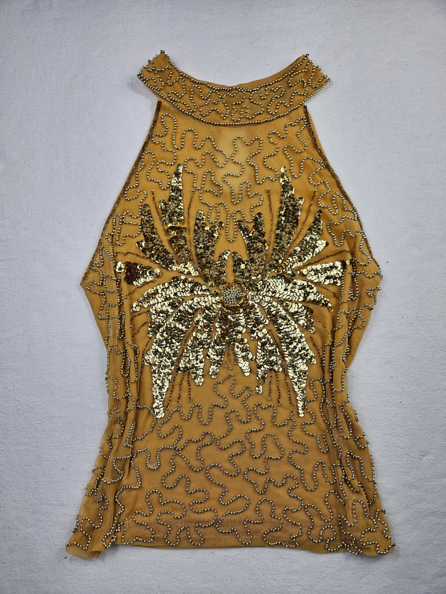 High-necked garment with gold sequins