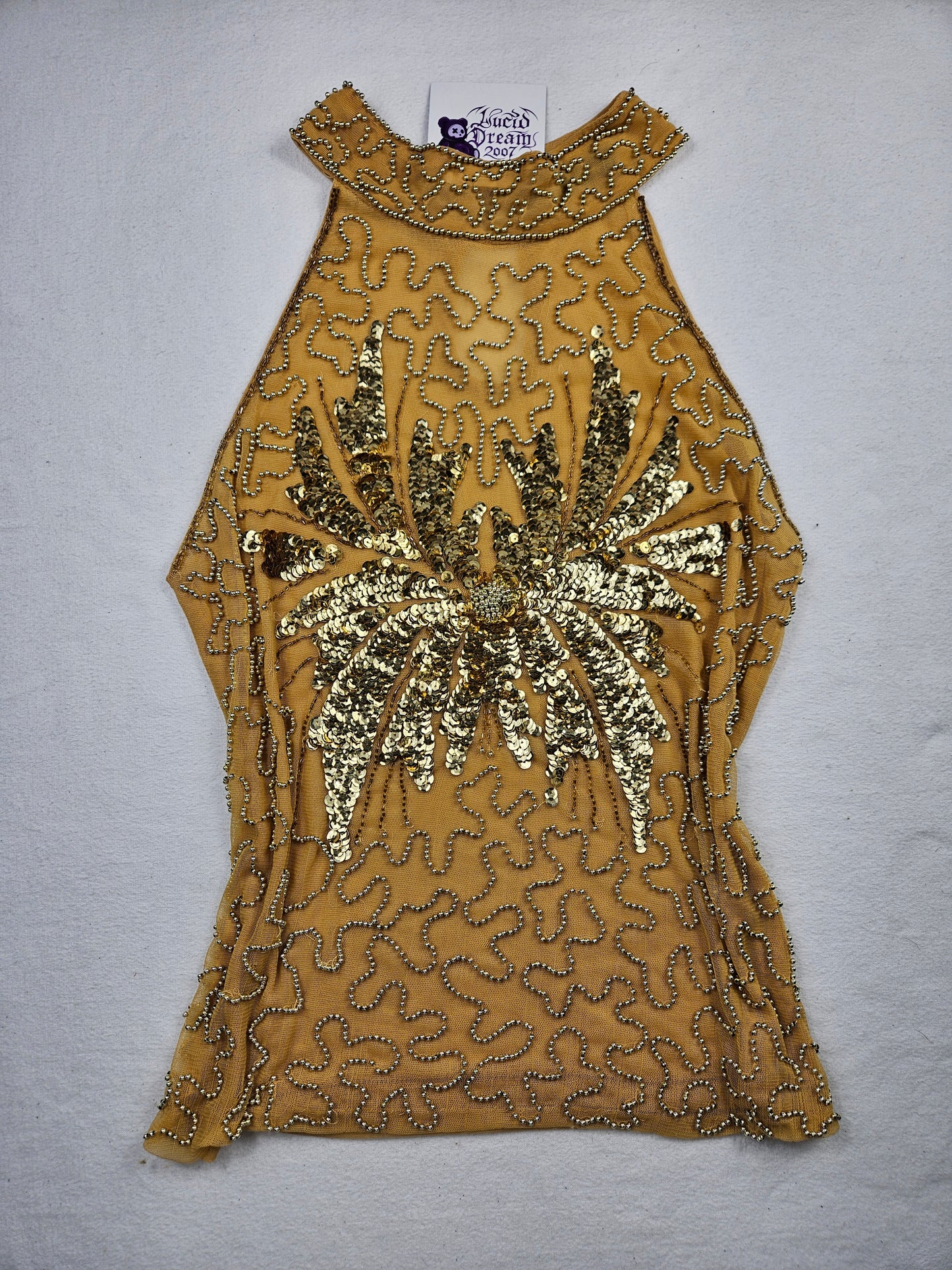 High-necked garment with gold sequins