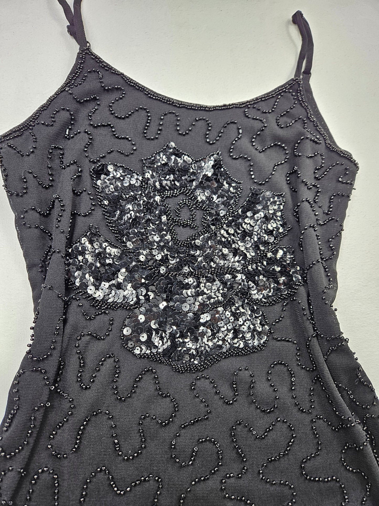 Top negro con lentejuelas en forma de flor