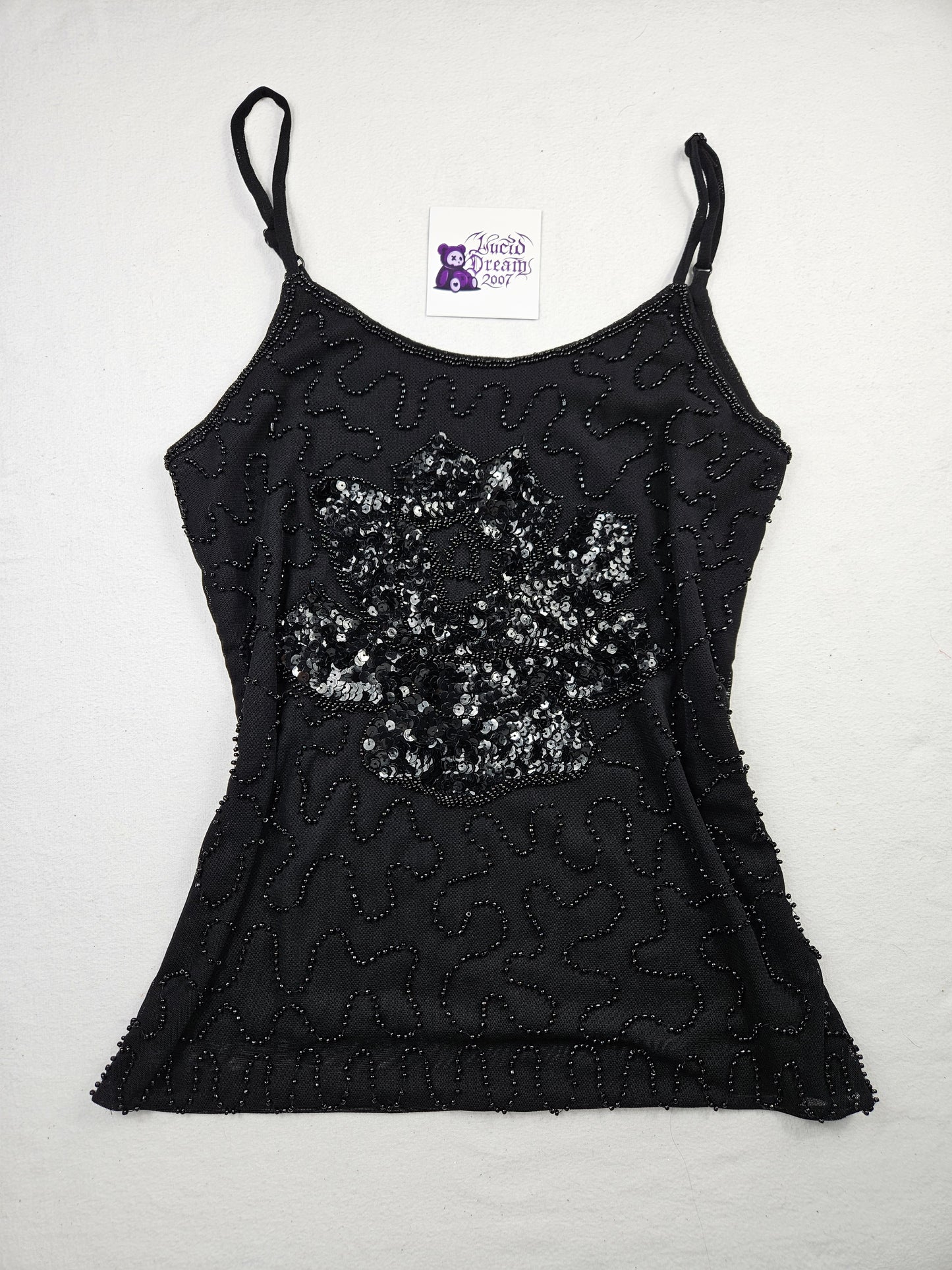 Top negro con lentejuelas en forma de flor