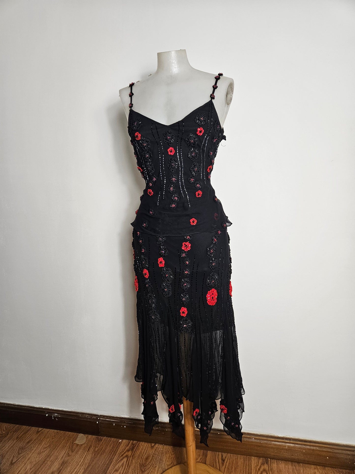 Black outfit embroidered with red roses