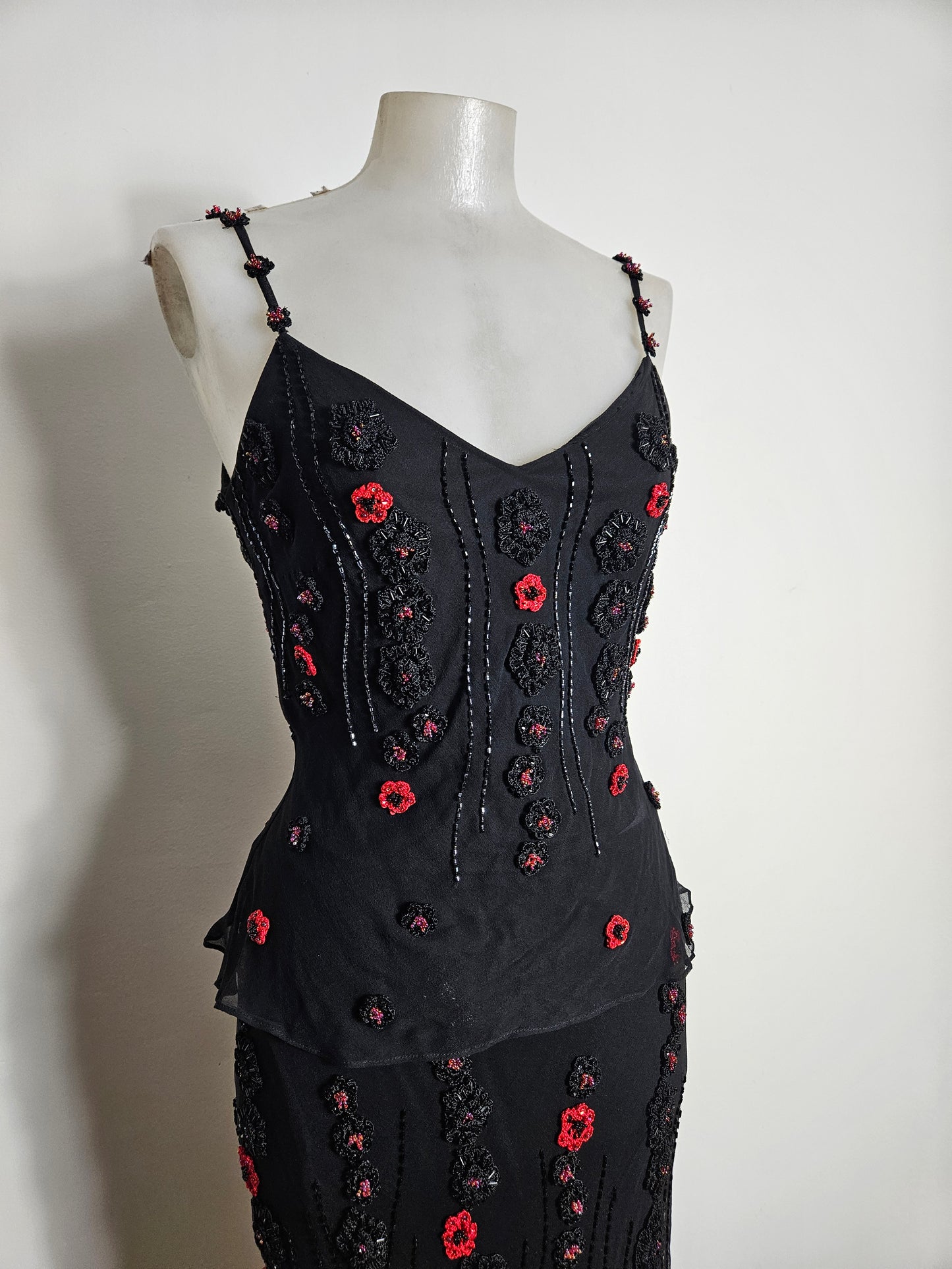 Black outfit embroidered with red roses