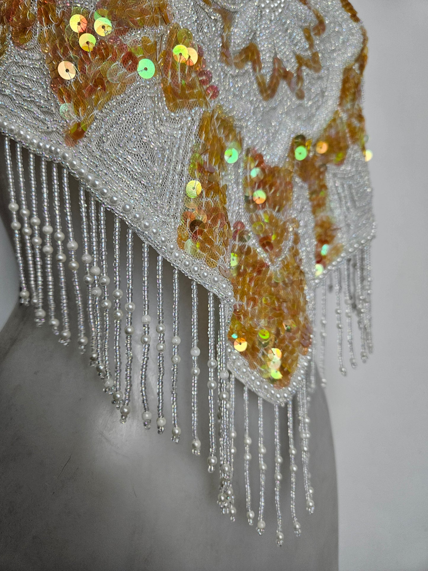 Espalda abierta bordada en blanco y dorado.