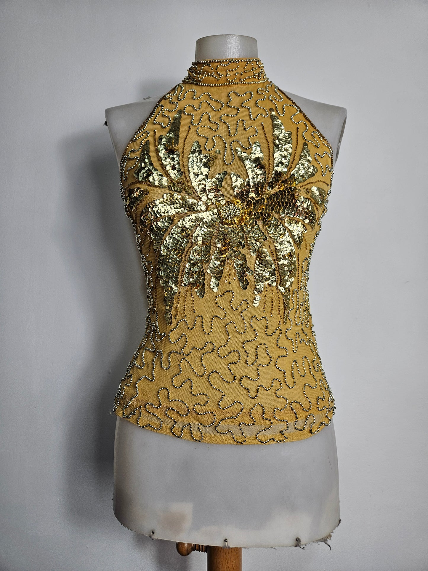 High-necked garment with gold sequins
