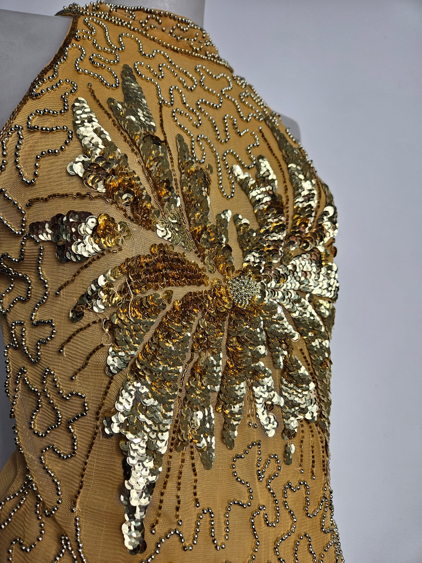 High-necked garment with gold sequins