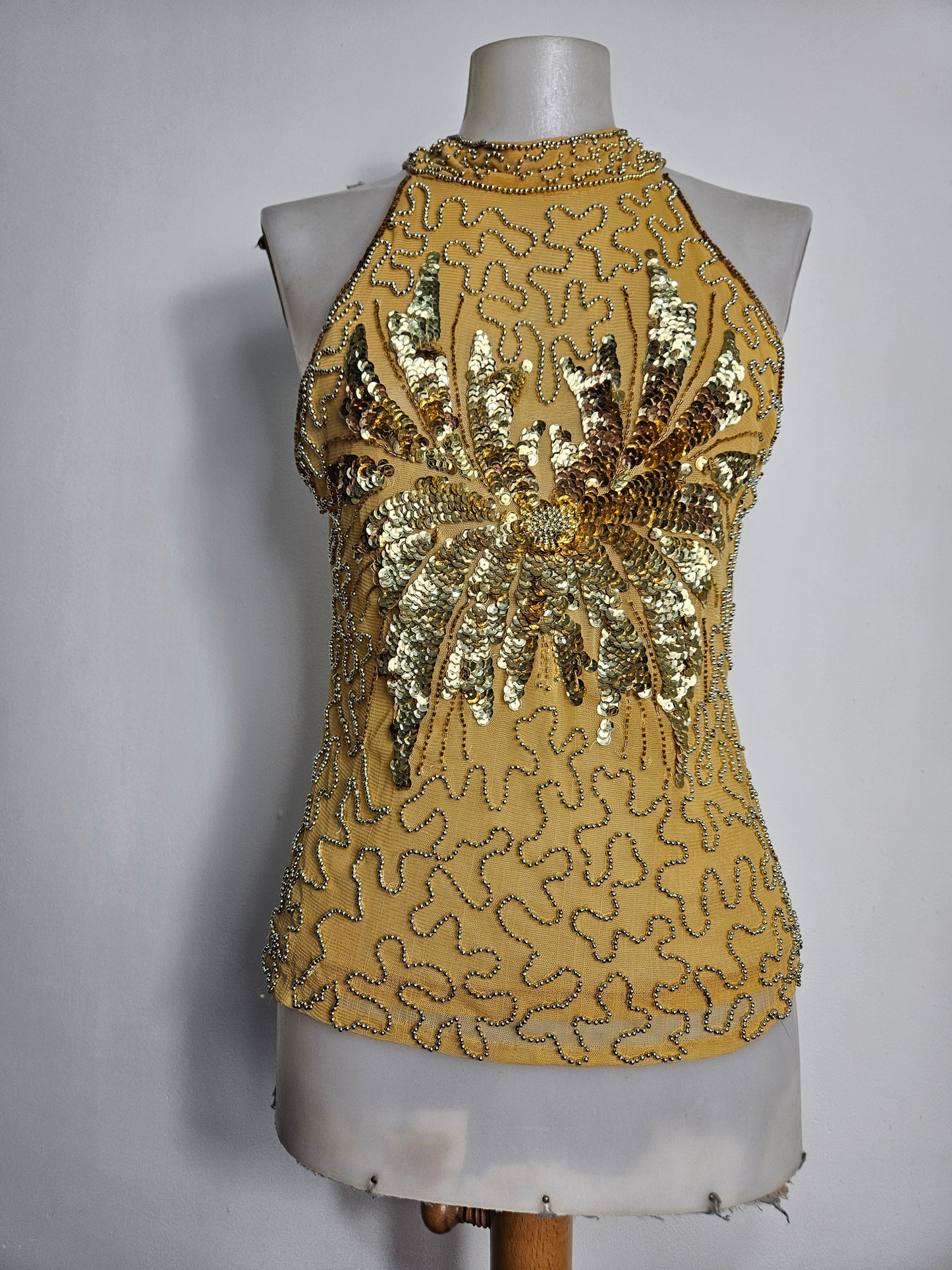 High-necked garment with gold sequins