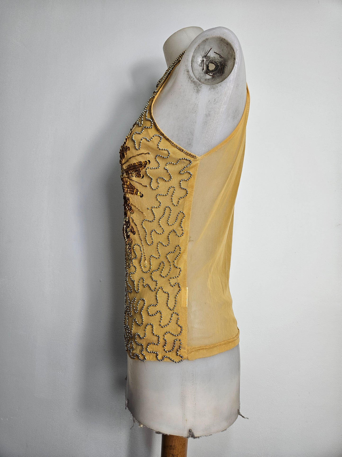 High-necked garment with gold sequins