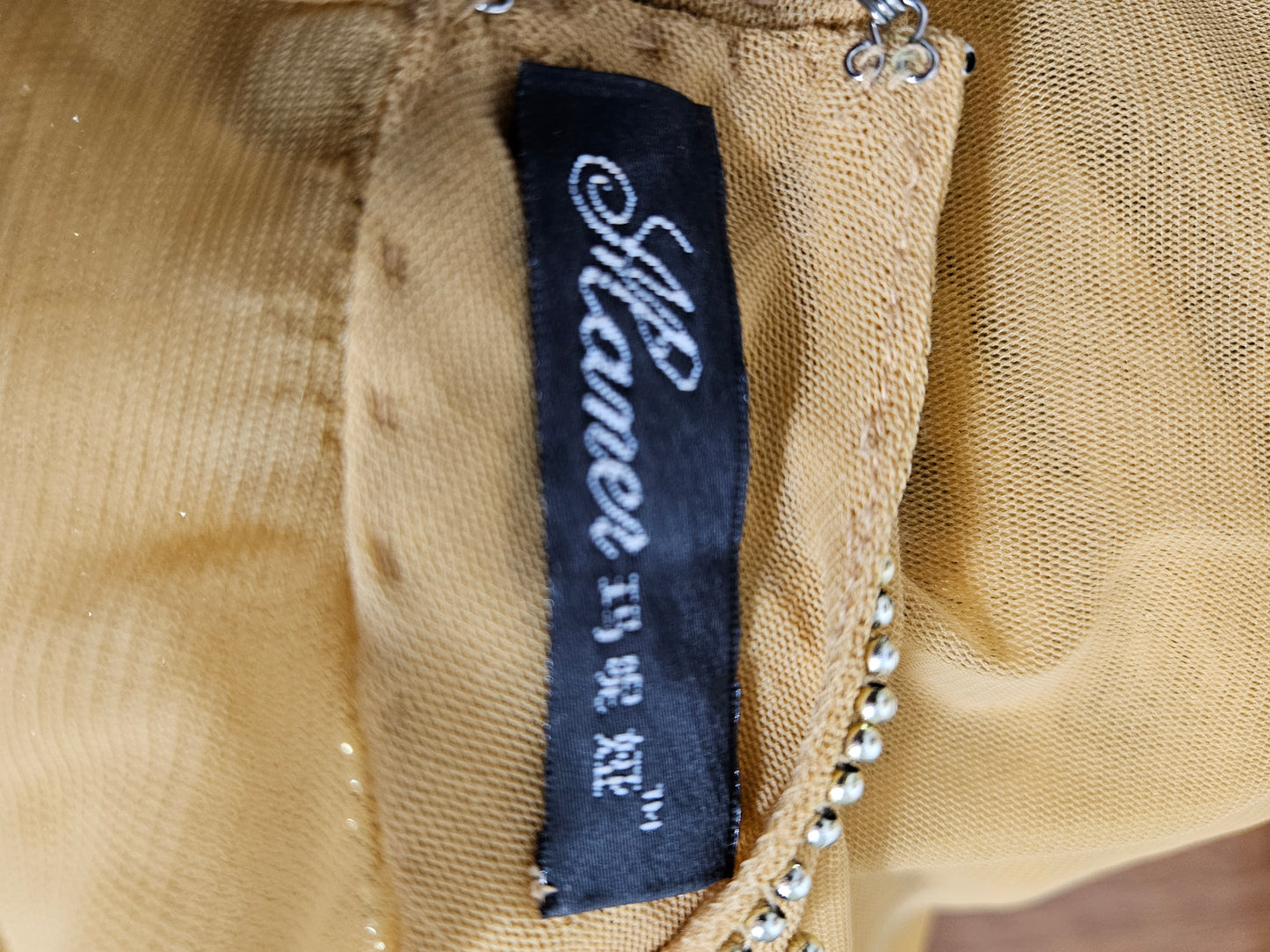 High-necked garment with gold sequins