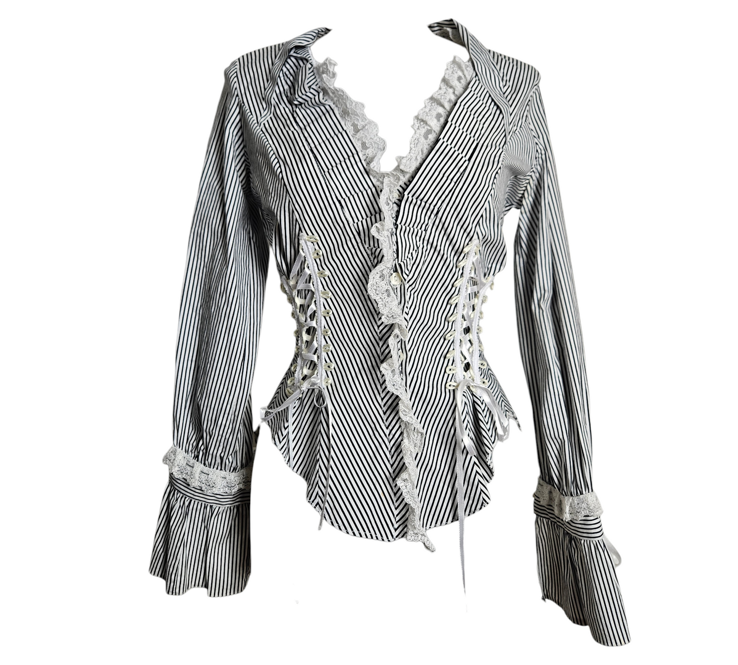 A stunning whimsigoth aesthetic blouse with black and white stripes, featuring intricate corset lacing with satin ribbons and delicate fairycore lace trim on the plunging neckline and flared cuffs.