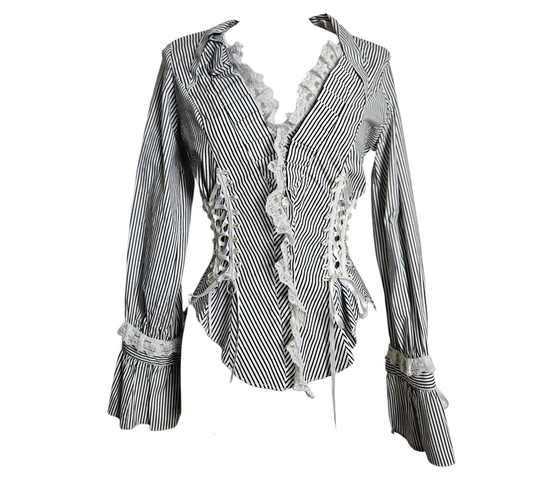 A stunning whimsigoth aesthetic blouse with black and white stripes, featuring intricate corset lacing with satin ribbons and delicate fairycore lace trim on the plunging neckline and flared cuffs.