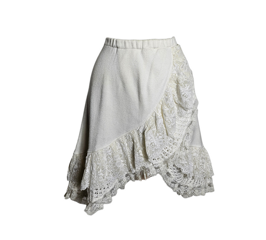 Ethereal fairycore white mini skirt with a comfortable elastic waist, featuring asymmetrical layers of delicate floral lace and ruffled embroidery for a soft cottagecore or reverie aesthetic.