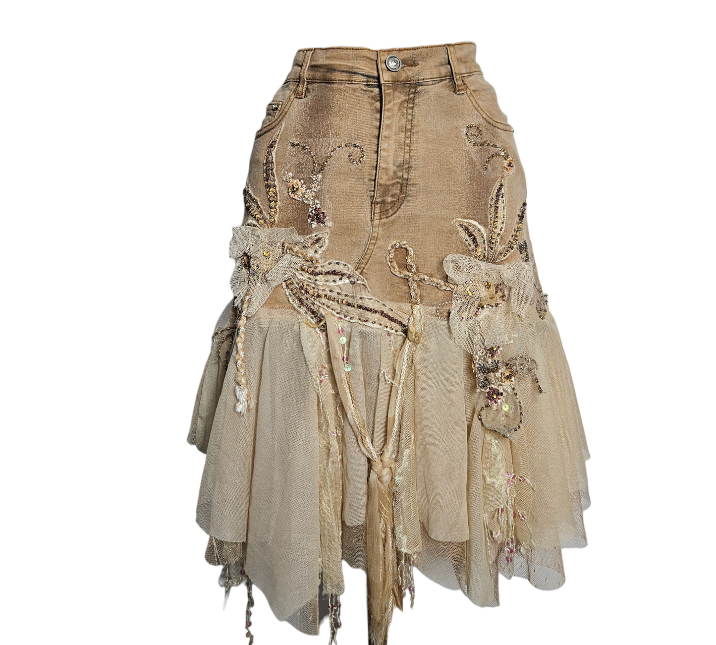 A mesmerizing fairycore denim skirt in sand beige, adorned with intricate floral embroidery, delicate pearls, and layers of ethereal nude tulle ruffles for a pure cottagecore reverie aesthetic.