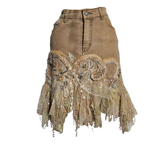 A mesmerizing fairycore denim skirt in sand beige, adorned with intricate floral embroidery, delicate pearls, and layers of ethereal nude tulle ruffles for a pure cottagecore reverie aesthetic.