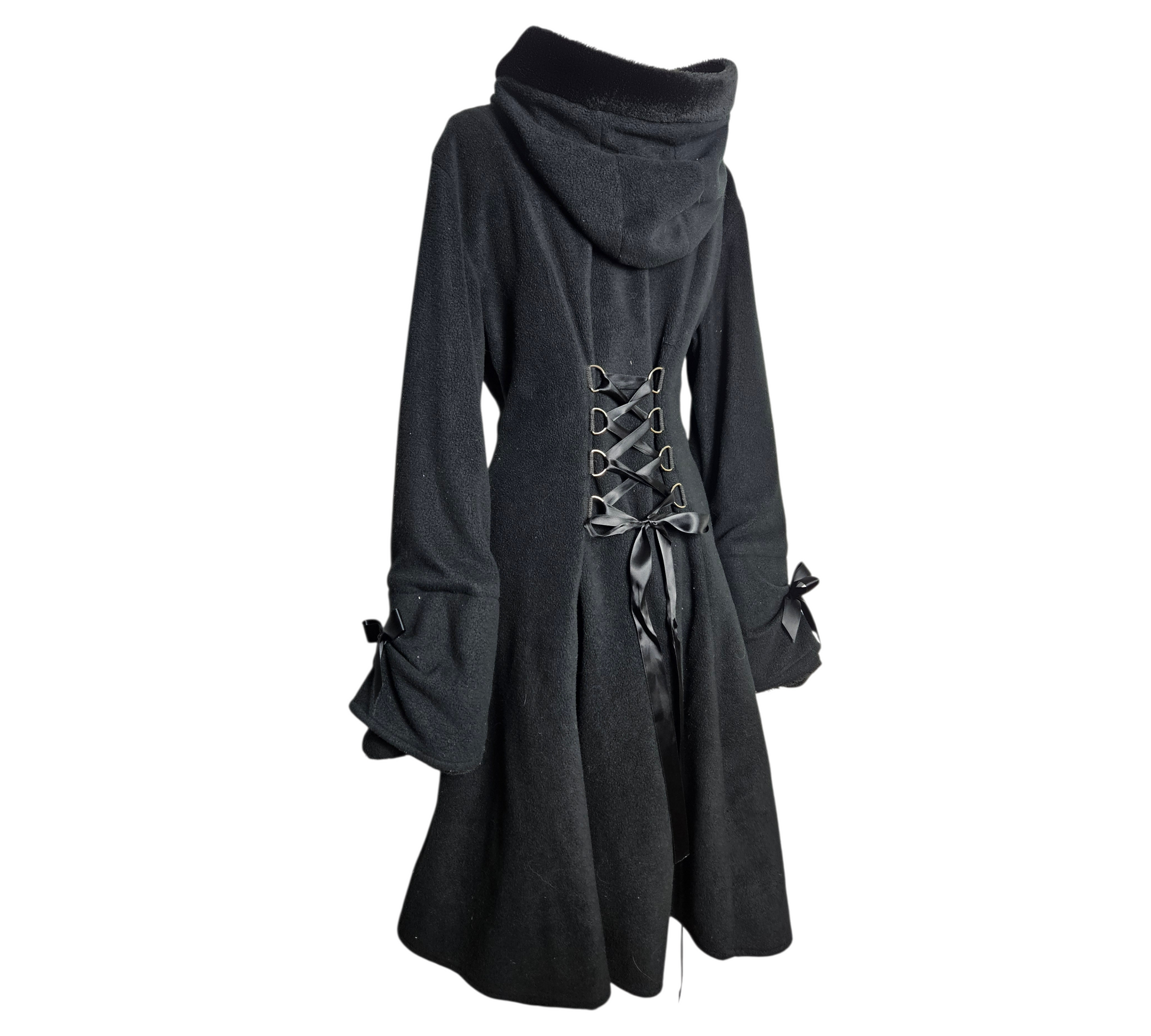 A cozy and magical black hooded coat with heart-shaped pockets, faux fur trim, and a corset-style ribbon lace-up back for a perfect whimsigoth or dark cottagecore look.