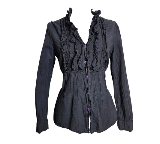 Whimsigoth aesthetic black cotton blouse with dramatic ruffles and crochet lace trim, accented by contrasting purple buttons for a dark fairycore look.