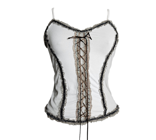 A dreamy Y2K aesthetic white camisole with earthy brown ribbon lacing and delicate whimsical lace trims, displayed on a mannequin.