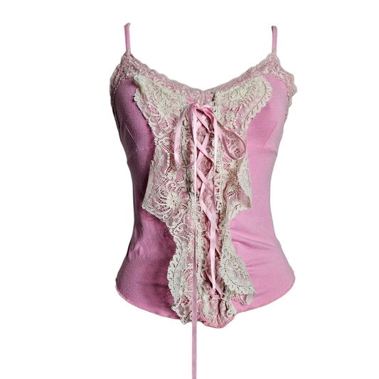 Y2K coquette aesthetic pink camisole featuring a dramatic cream lace butterfly-shaped panel with satin ribbon corset lacing for a soft fairycore or sugary reverie look.