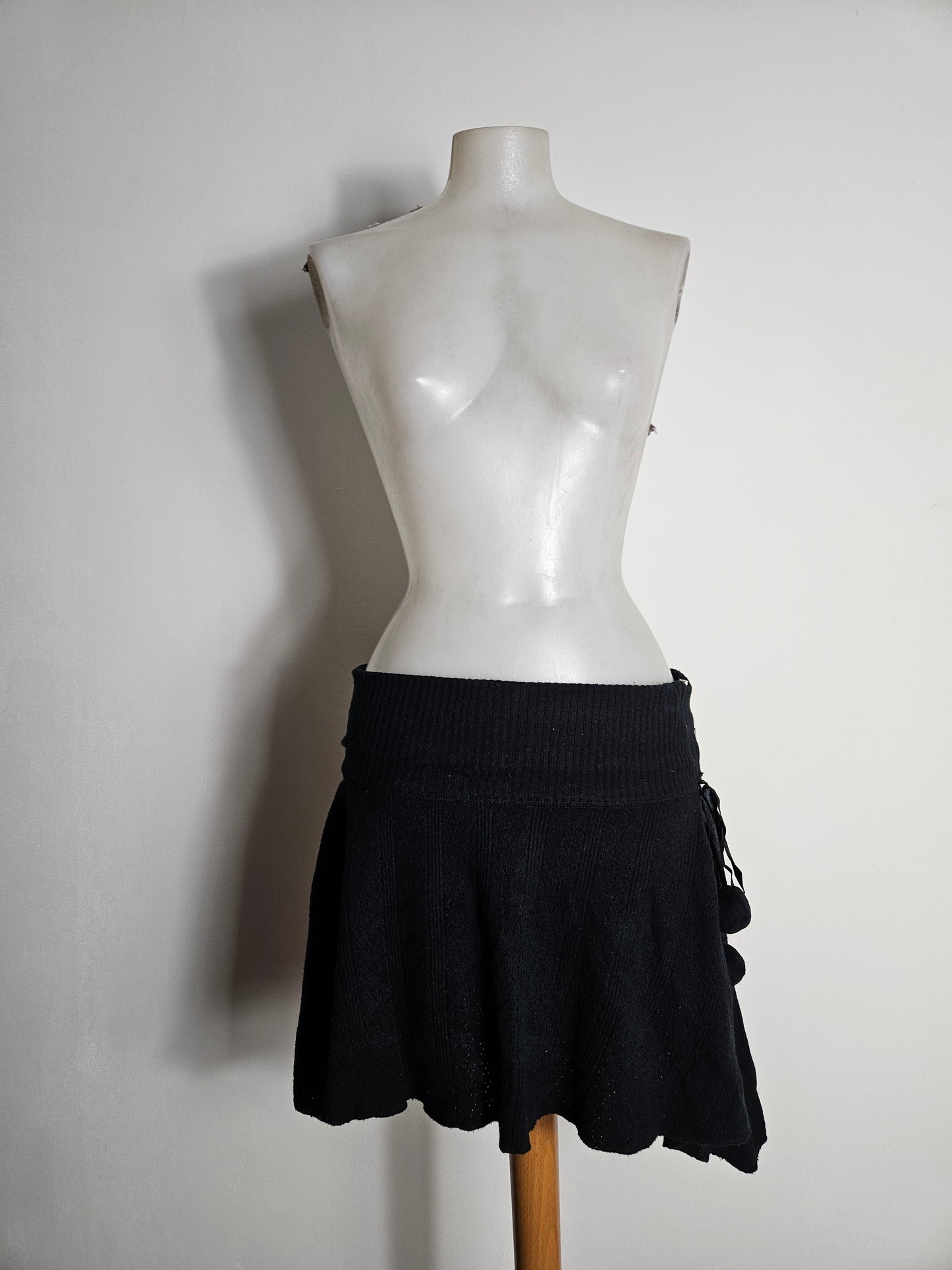 Asymmetrical mini skirt with pom-pom details
