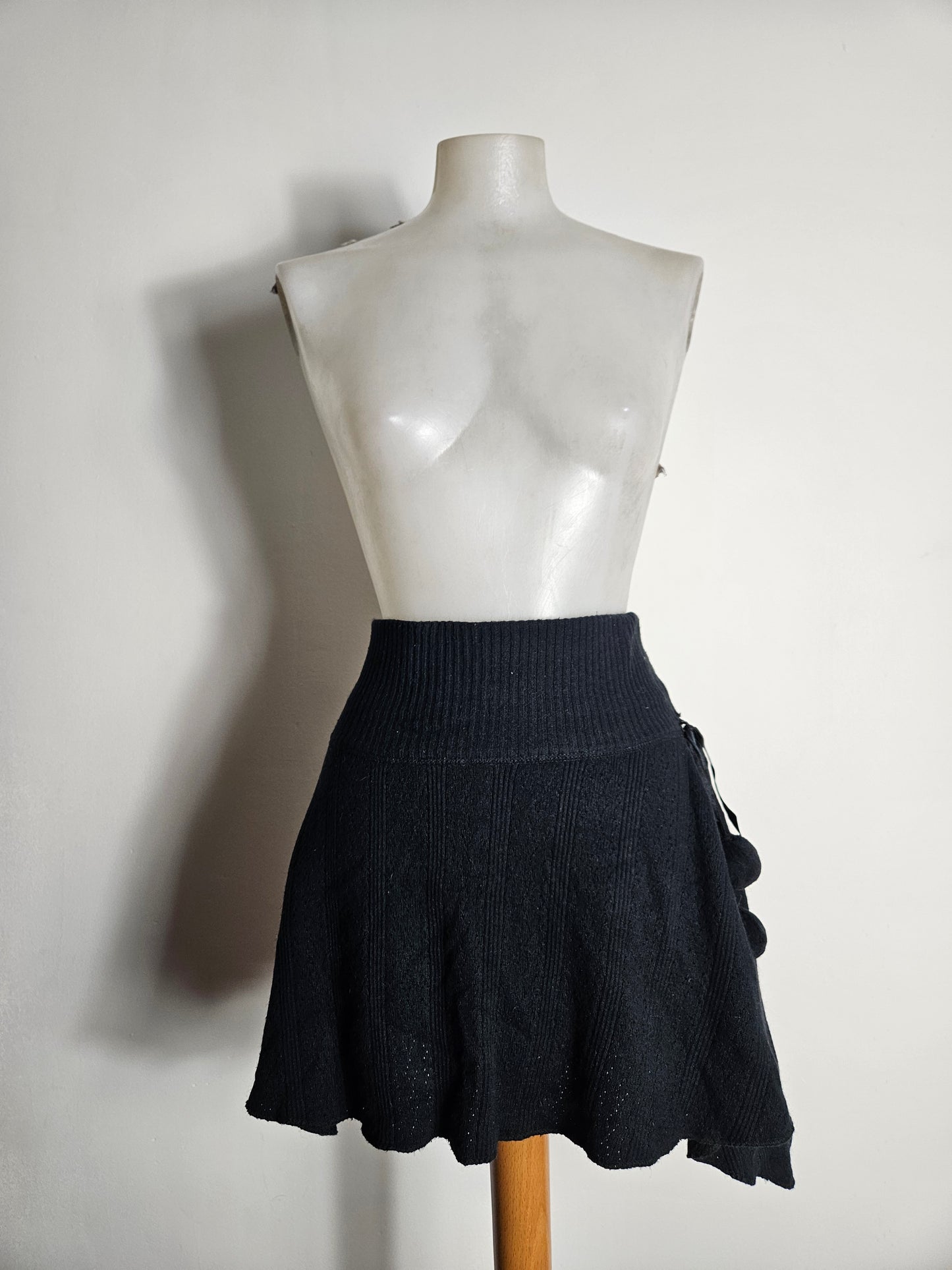 Asymmetrical mini skirt with pom-pom details
