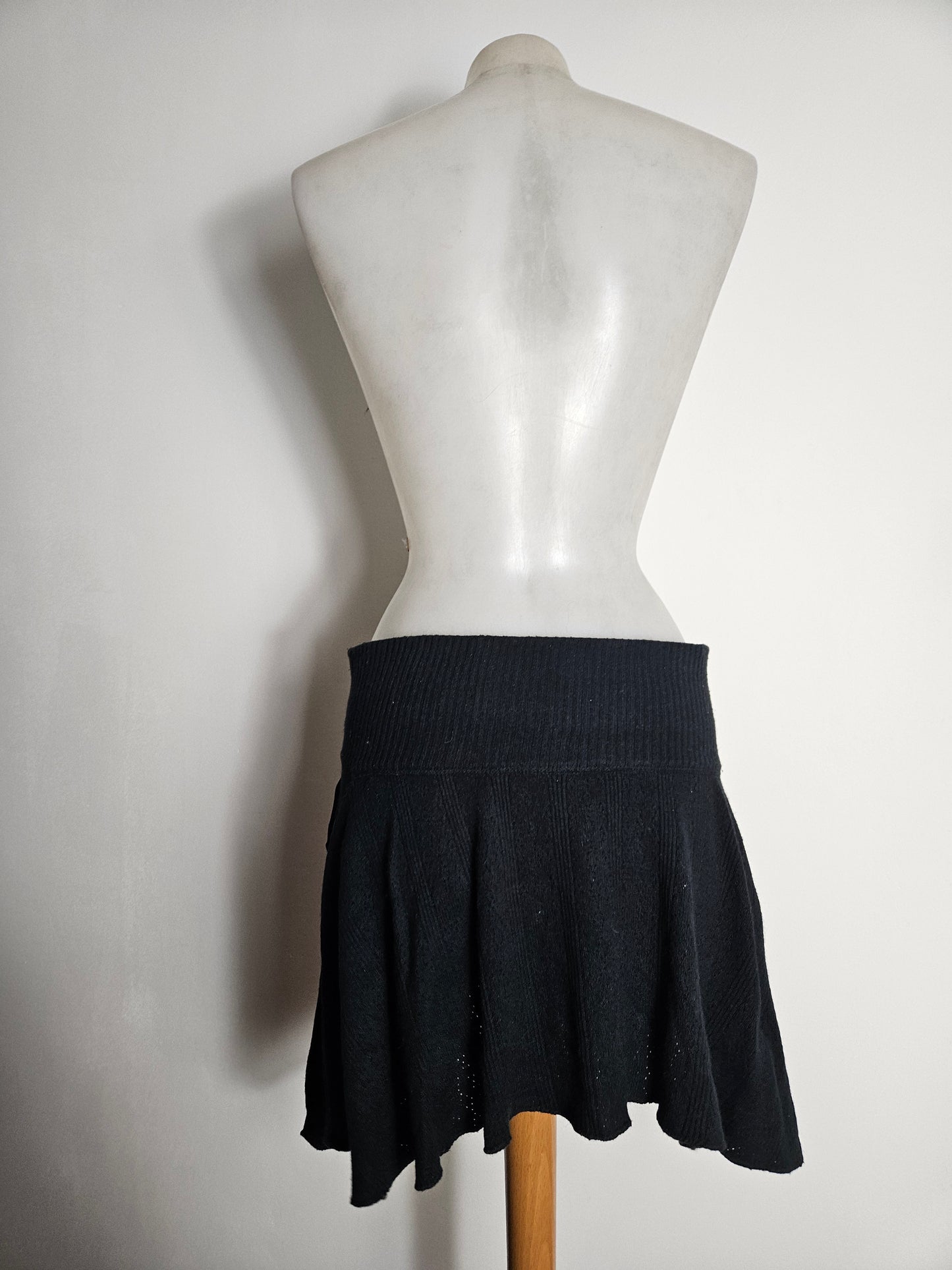 Asymmetrical mini skirt with pom-pom details