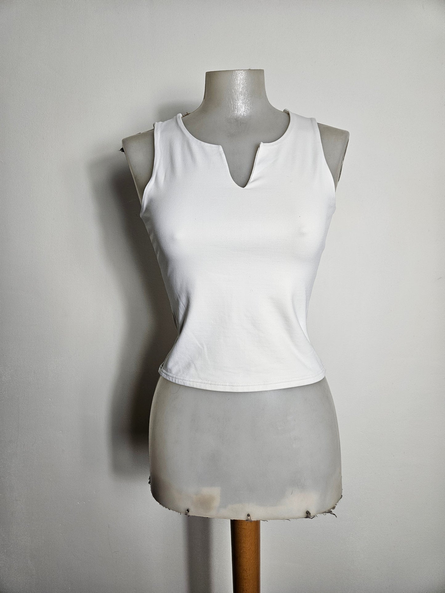 White fitted top with a small V-neck