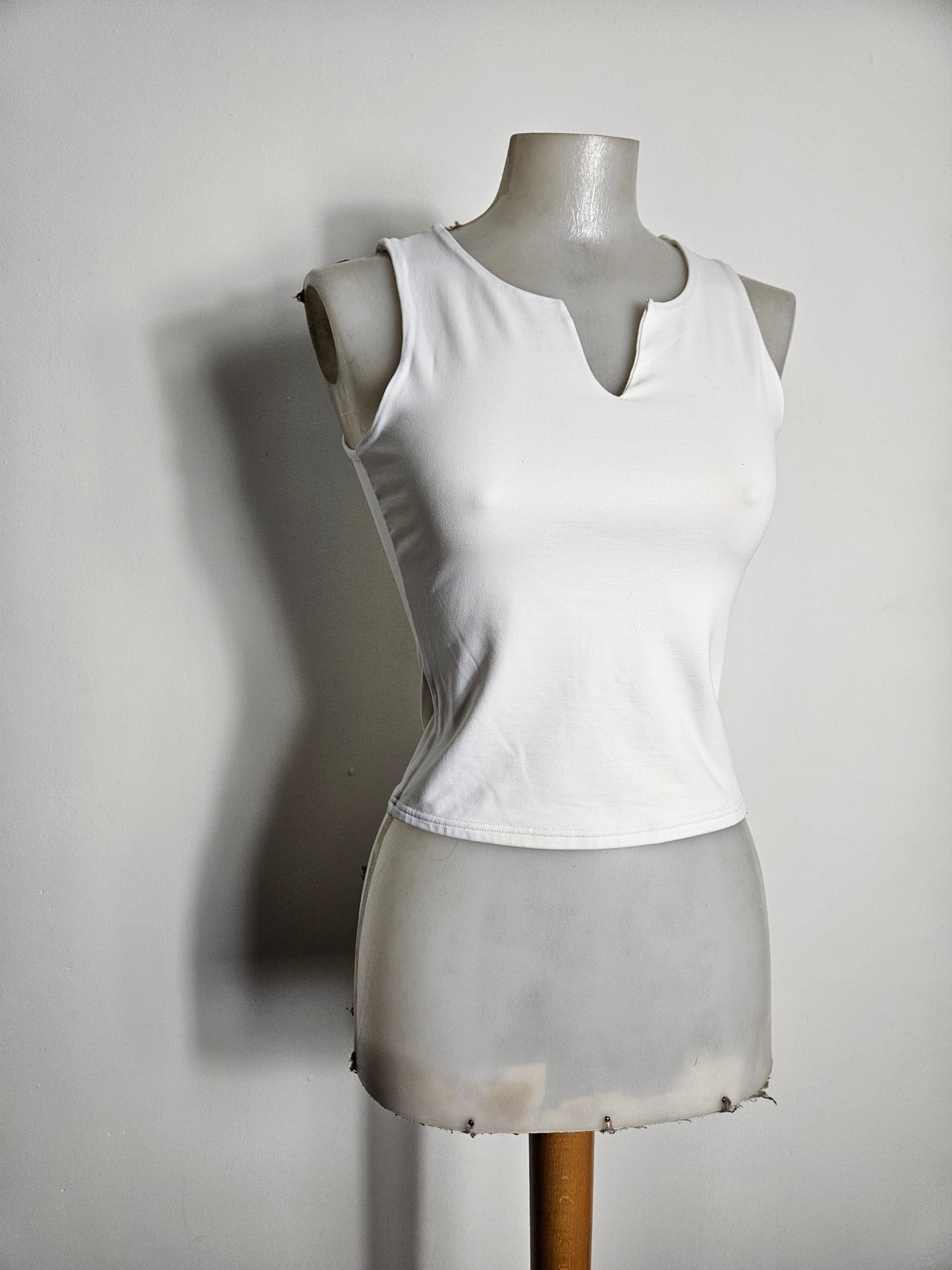 White fitted top with a small V-neck