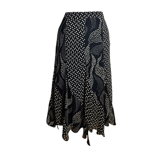 Vintage black polka dot midi skirt with flowing wavy pattern and flared hem, elegant Y2K retro silhouette with whimsical fairycore and romantic vintage vibes.