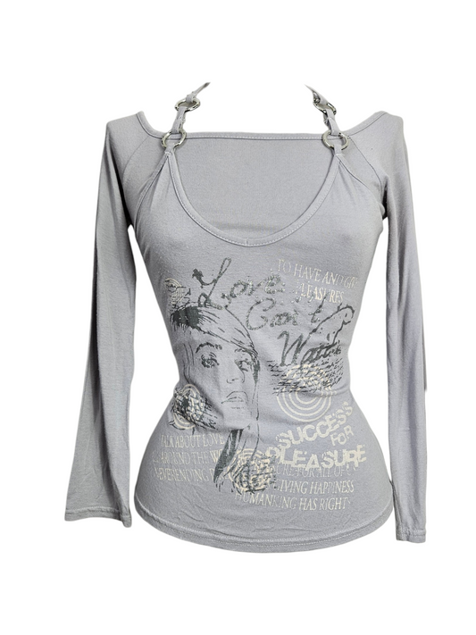Lavender long-sleeve top with a female portrait graphic, typography, and silver metal O-ring details at the neckline. Cyber Y2K grunge aesthetic on a mannequin.