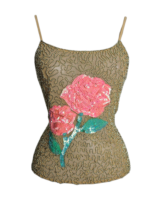 Vintage beaded camisole with pink sequin rose detail. Gold beaded mesh overlay on a beige top. Elegant Y2K party wear or glam evening aesthetic crop top.
