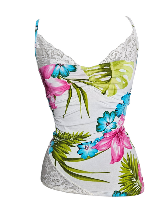 White tropical floral camisole with pink hibiscus, teal flowers, and white lace trim on a mannequin.