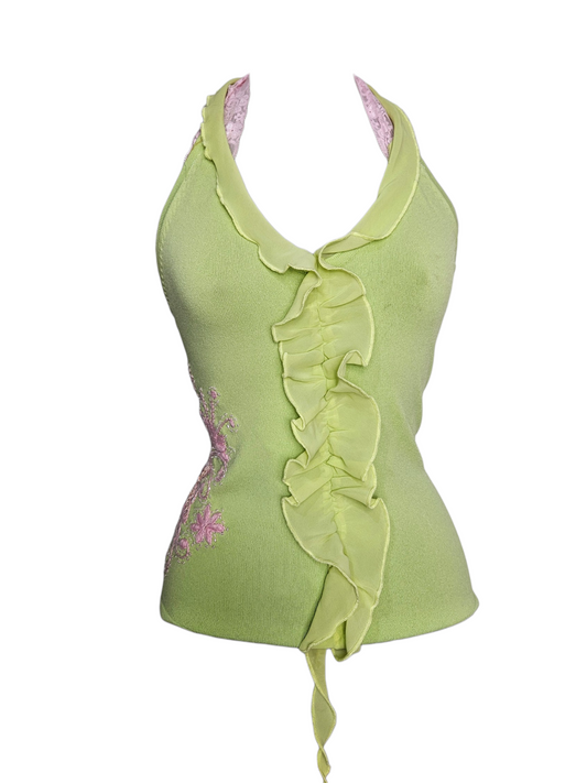 Lime green halter top with ruffle trim, pink floral embroidery, and lace straps on a mannequin.