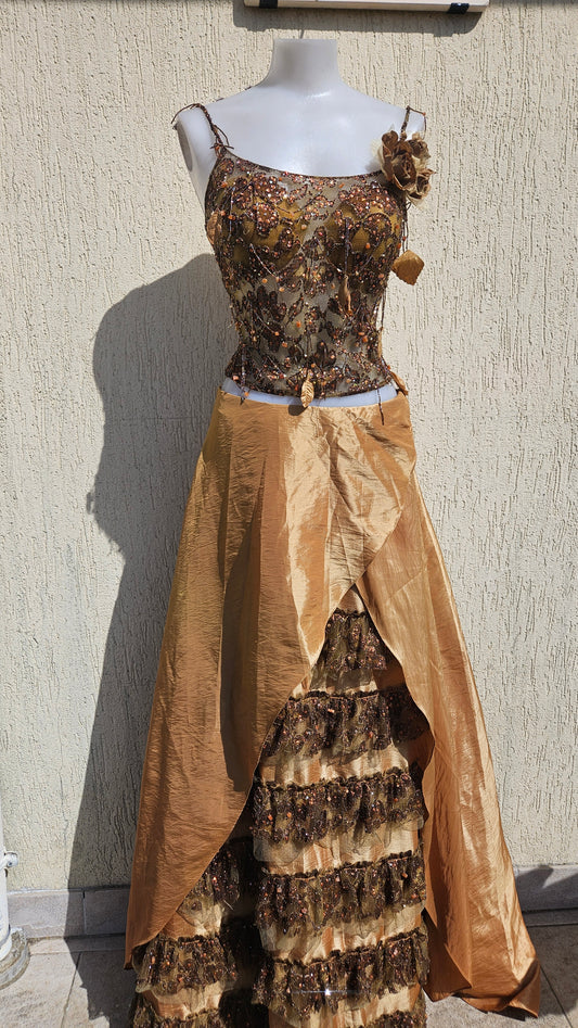 Gold & bronze corset gown with sequin embroidery, floral shoulder detail, and layered ruffle skirt. Fairycore evening dress for formal events on mannequin.