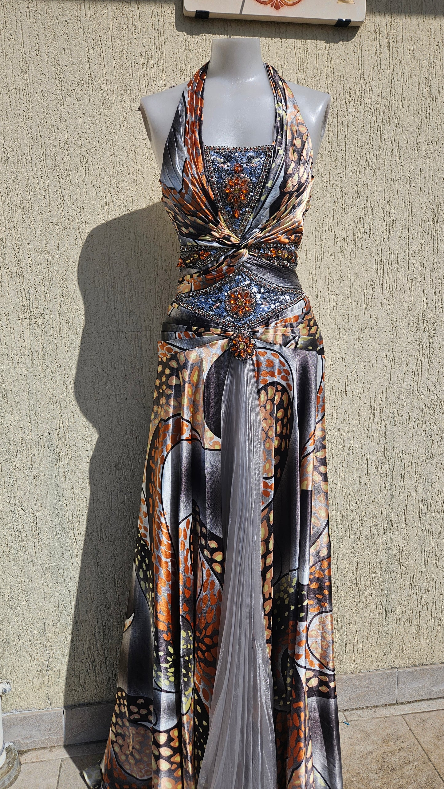 Vintage Y2K satin halter neck gown, featuring bold gray/orange patterns, intricate beaded orange and silver bodice appliques, and a sheer pleated center skirt panel.