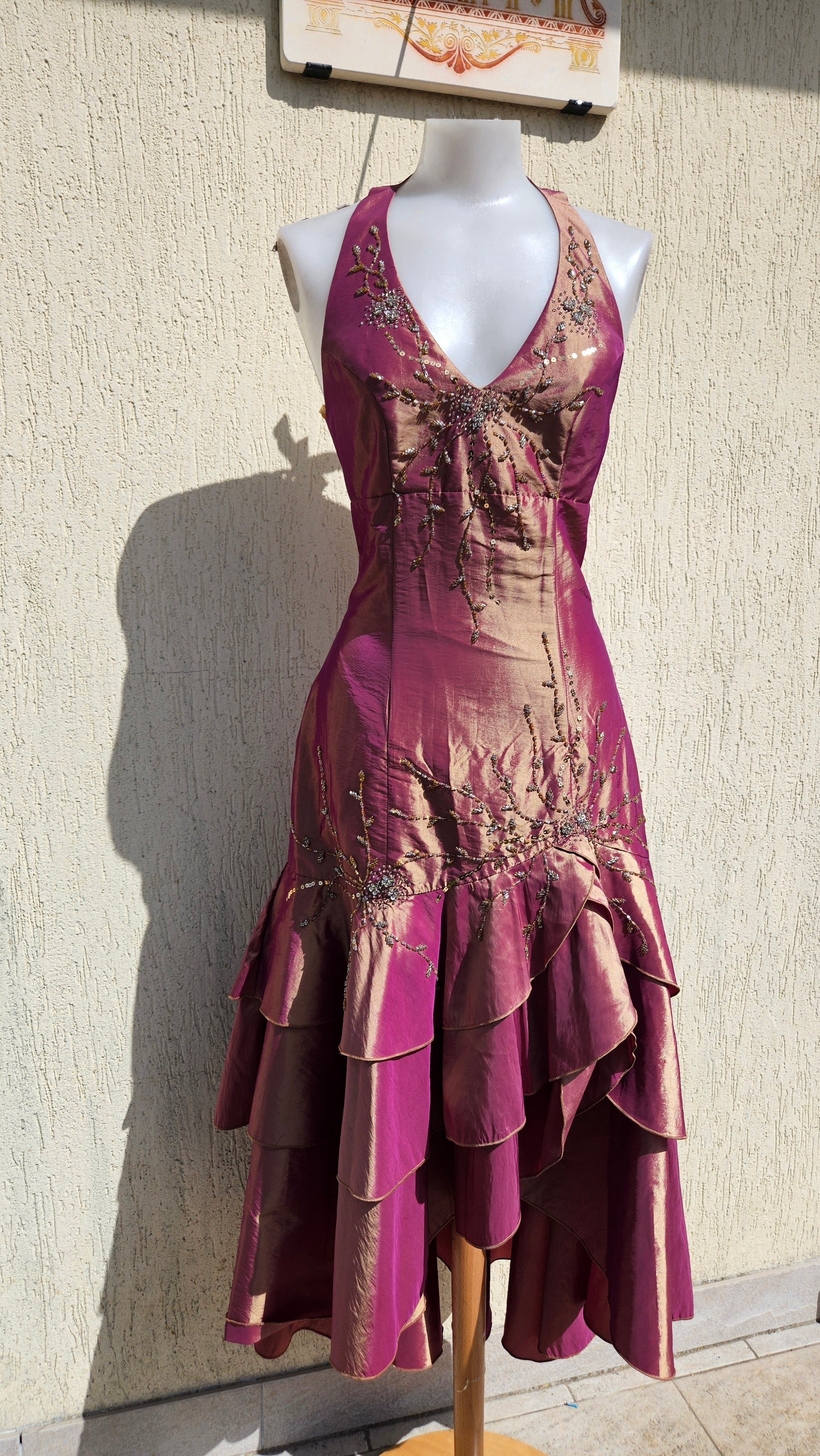 Y2K iridescent magenta halter prom dress with bronze floral beadwork and tiered ruffle high-low skirt.