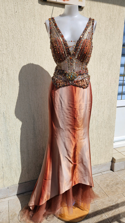 Unique bronze and rust orange beaded evening gown with detailed beadwork, large gold buckle, and high-low tulle skirt.