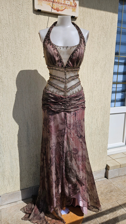 Mauve halter neck mermaid gown with sheer beaded midriff, floral print overlays, and sequins. Elegant vintage evening dress for prom or formal galas.