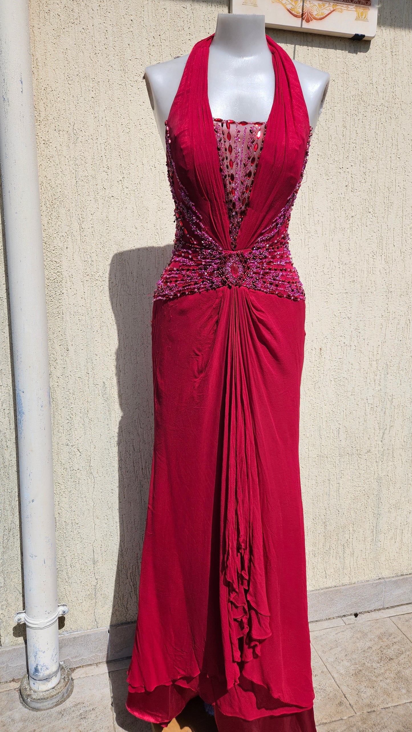 Elegant magenta halter evening gown with intricate beadwork and ruffles. Stunning vintage-inspired formal dress for gala or prom.