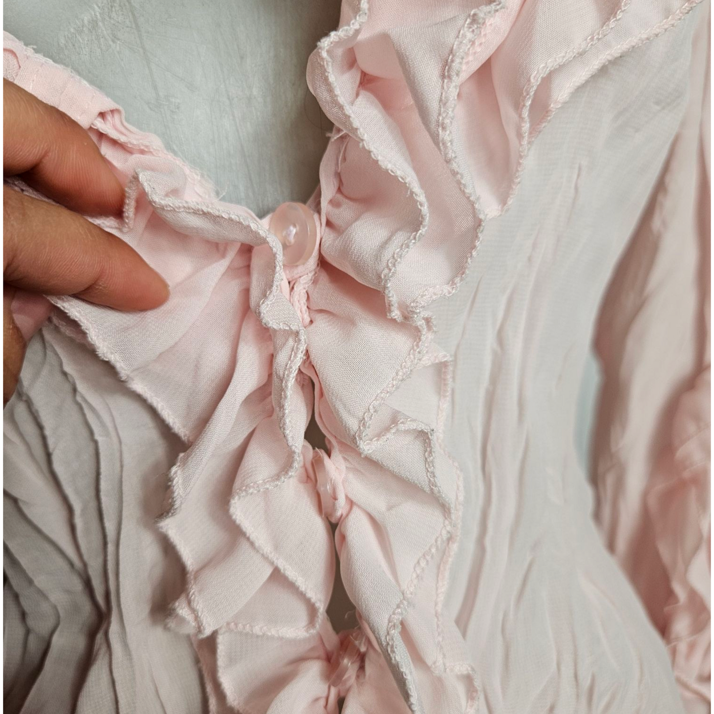 Pale pink ruffled blouse