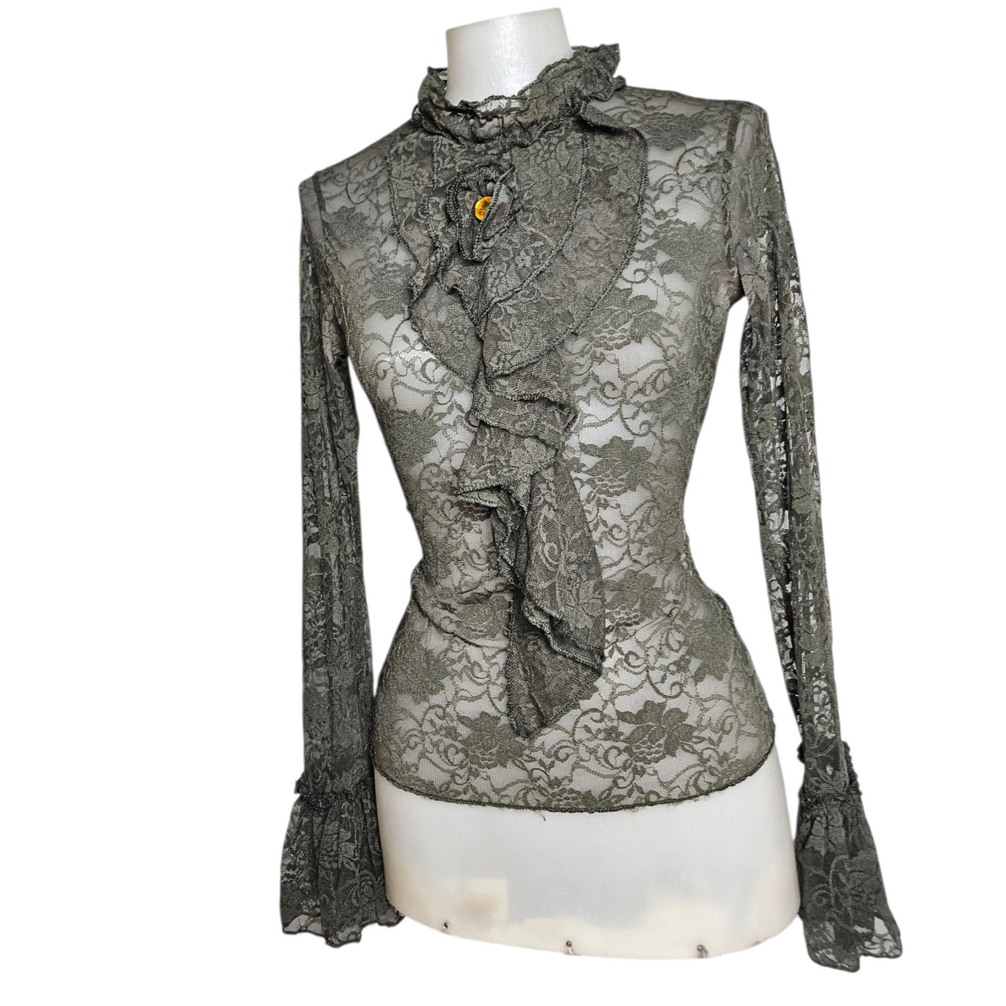 Lace blouse with ruffle details and brooch