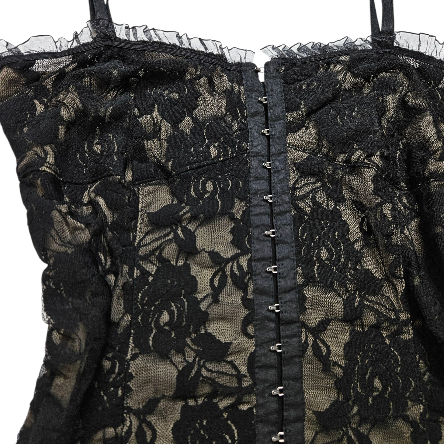 Black lace corset top on a beige background