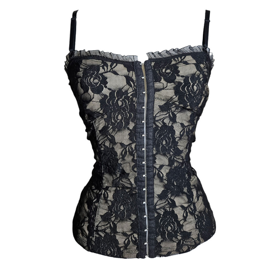 Black lace corset top on a beige background