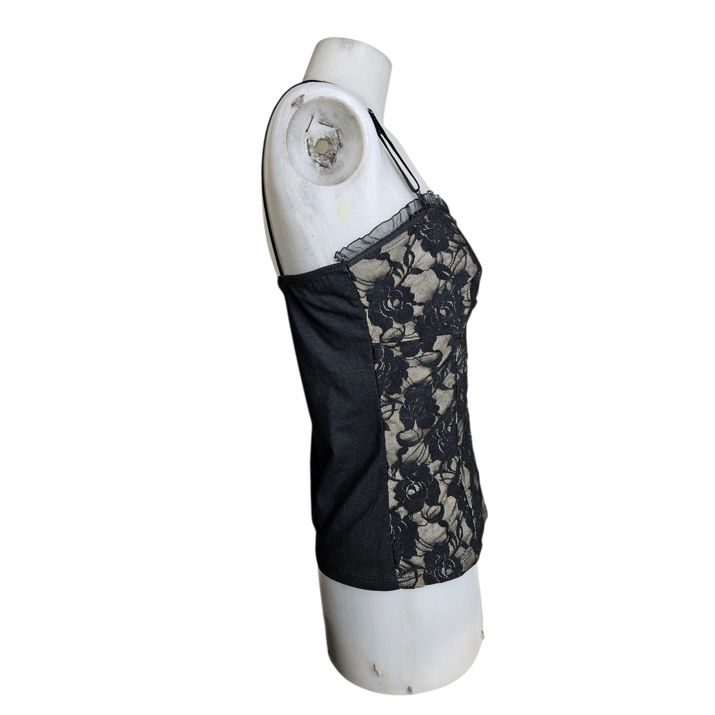 Black lace corset top on a beige background