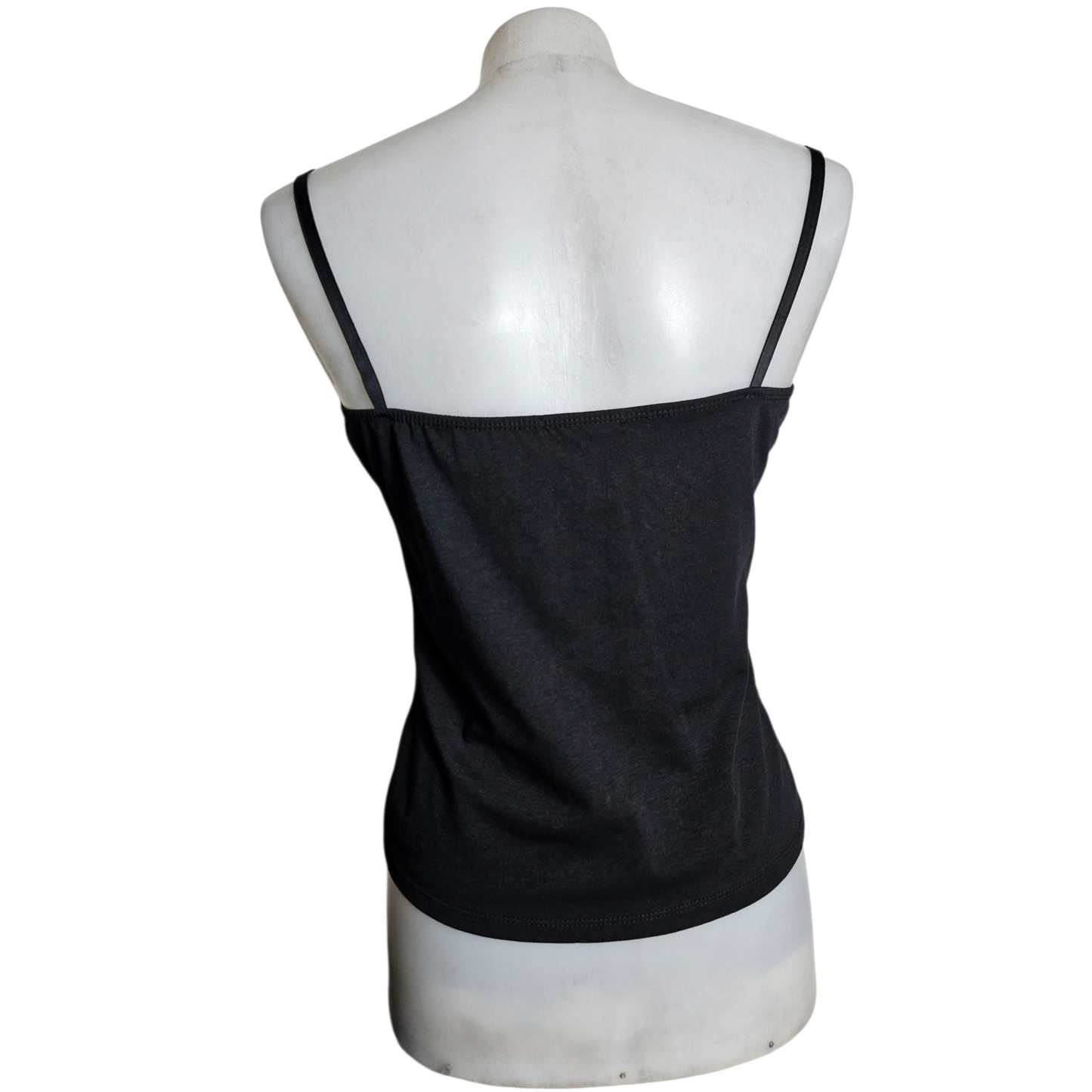 Black lace corset top on a beige background