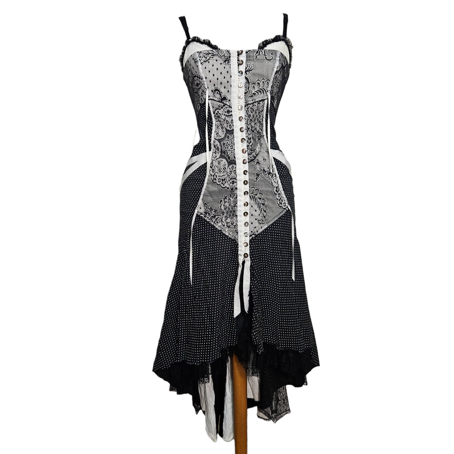 Vintage black and white corset dress with lace panels and button front, photographed from the front on white background