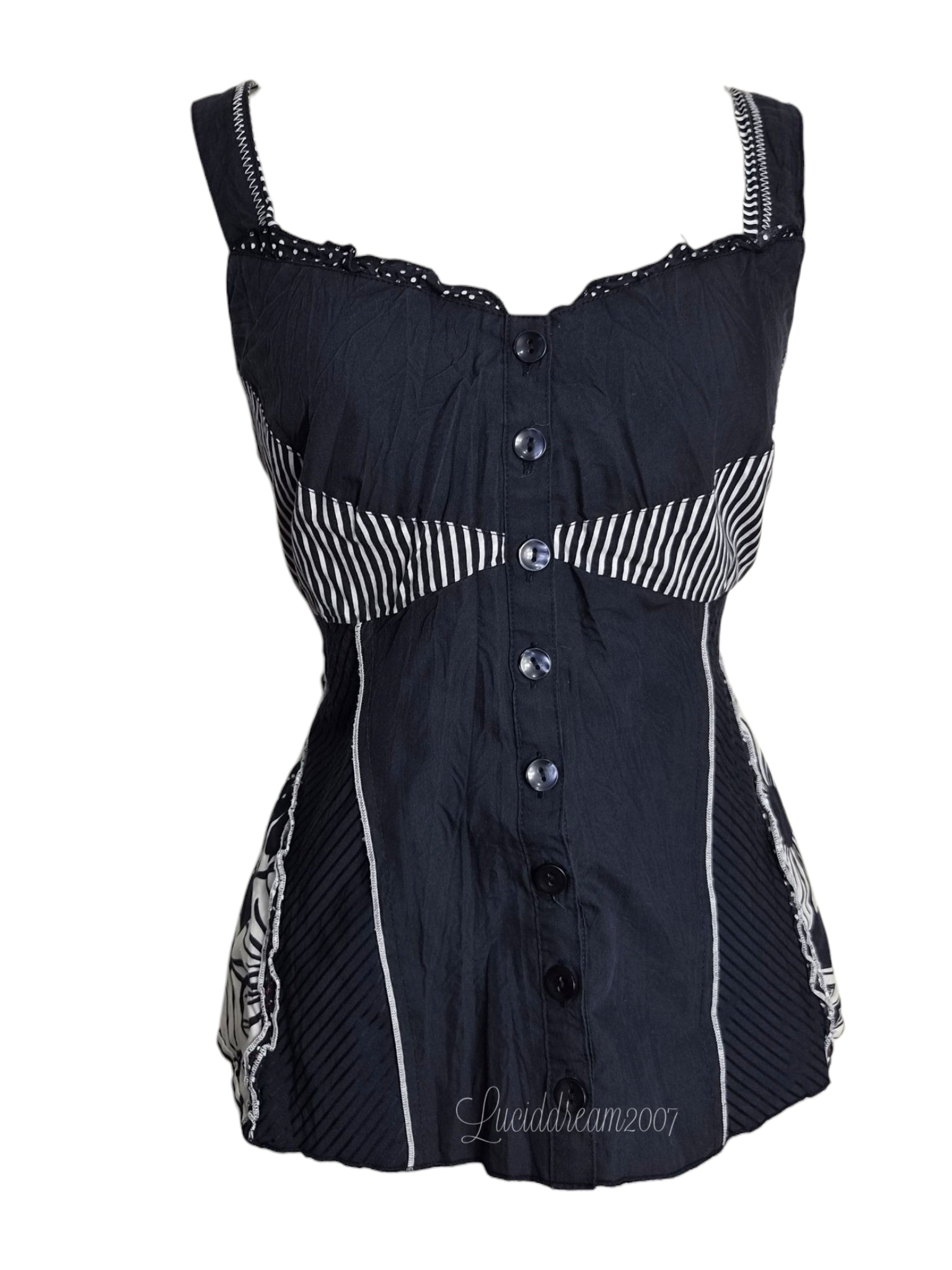 Haut bleu marine avec empicements à pois blanc. Laçage au dos pour s'ajuster. Pièce vintage y2k